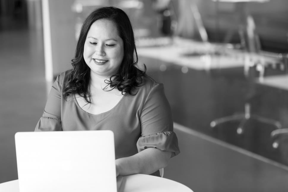 Free Image of Happy Businesswoman with laptop in office - b&w 