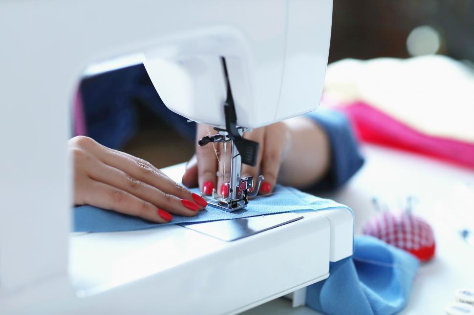 Free Image of Seamstress sewing on machine 