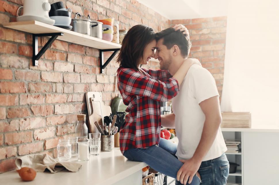 Free Image of Happy couple flirting in the kitchen 