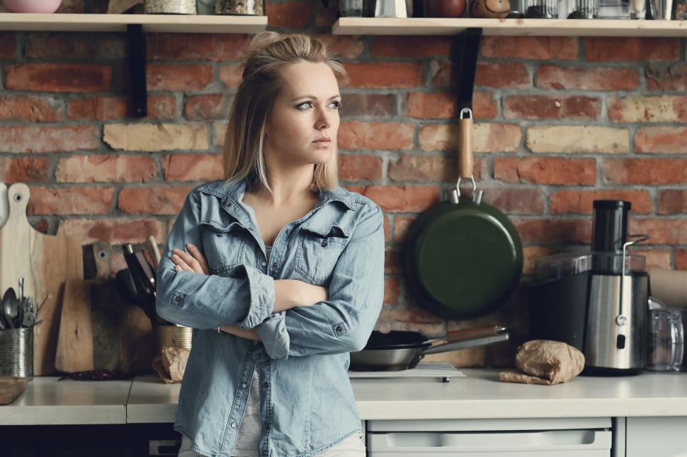 Free Image of Woman with arms crossed in kitchen 