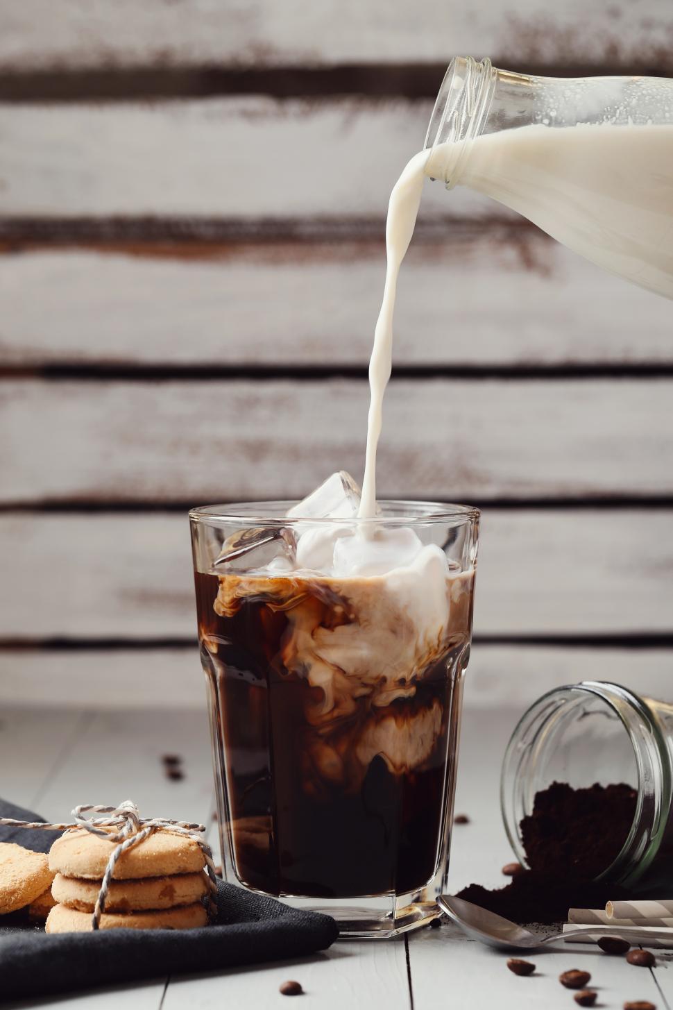 Free Image of Pouring milk into iced coffee 
