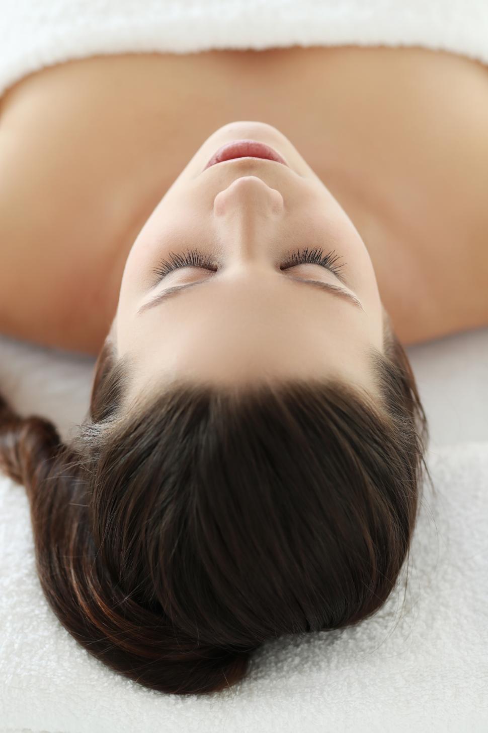 Free Image of Woman laying down on spa treatment table 