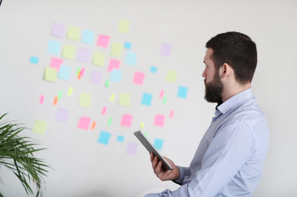 Free Image of Man pondering sticky notes 