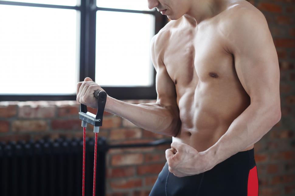 Free Image of Man doing curls with resistance bands 