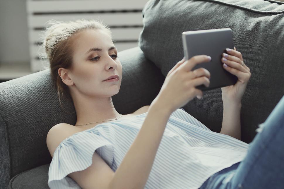 Free Image of Woman lounging with tablet computer 