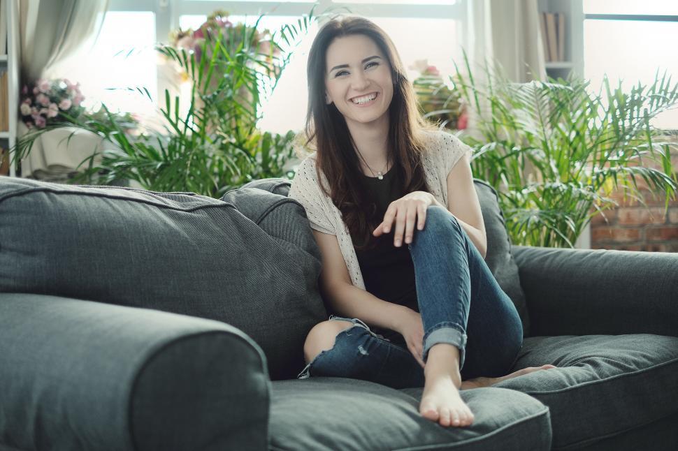 Free Image of Happy woman on the couch 