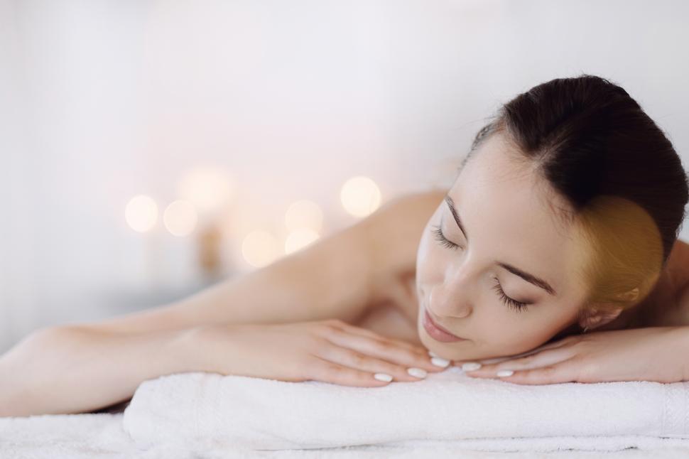 Free Image of Woman laying down, relaxed at spa 