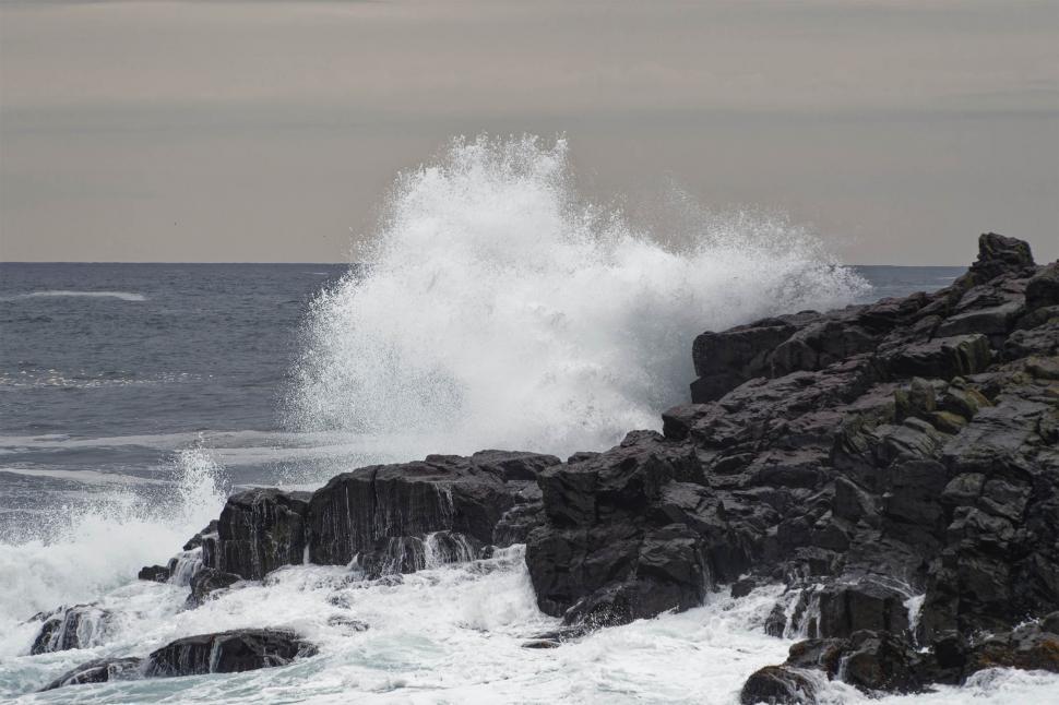 Download Free Stock Photo of Wave breaking on a rocky out crop 