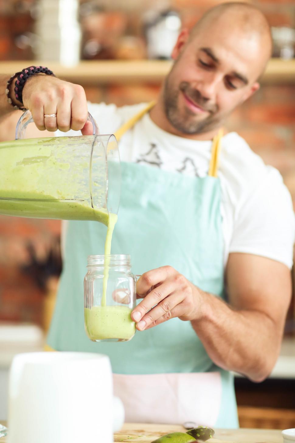 Free Image of Man pouring a smoothie 