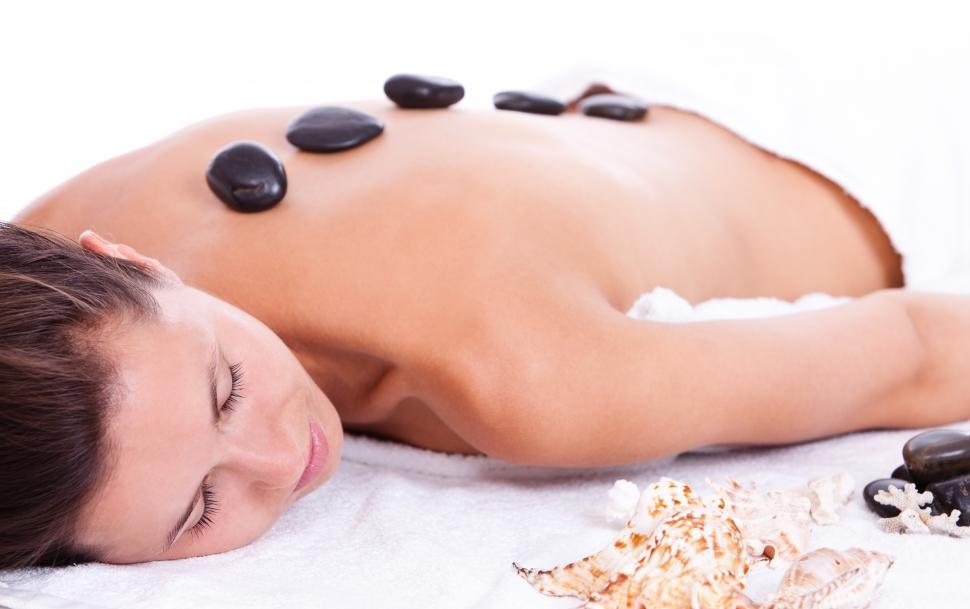Free Image of Young woman enjoying massage therapy stones 