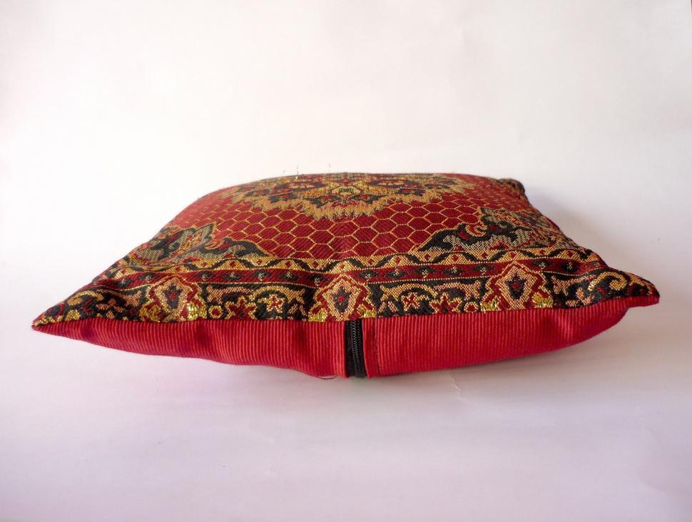 Free Image of Red Pillow With Decorative Pattern 