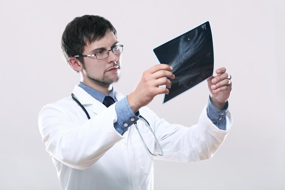 Free Image of Young doctor looking at x-ray image 