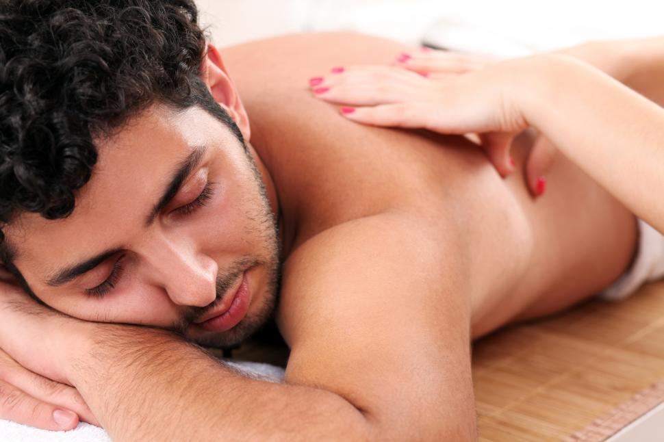Download Free Stock Photo of Handsome guy during massage therapy 
