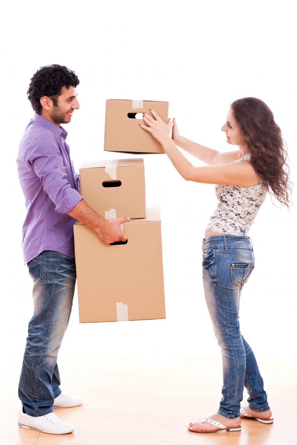 Free Image of Young and happy couple are carrying boxes 
