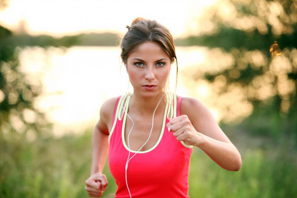 Download Free Stock Photo of Healthy young woman on an evening jog 