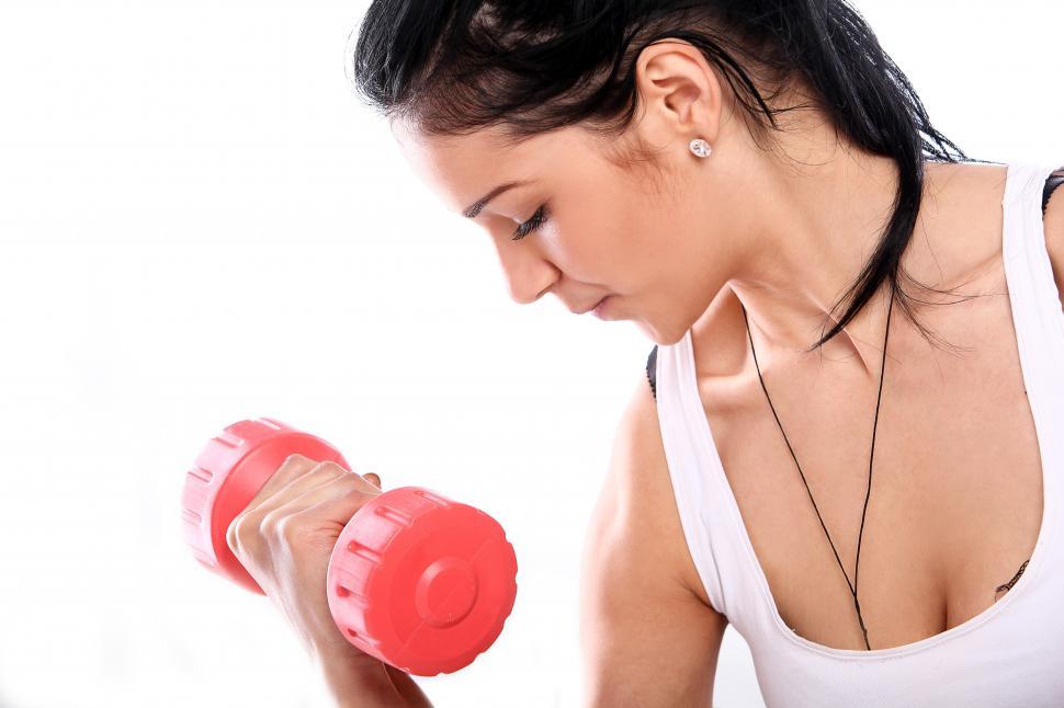 Download Free Stock Photo of Woman doing curls with red barbell 