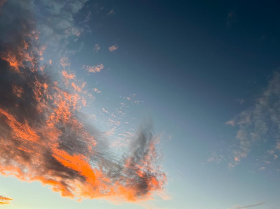 Free Image of Dramatic blue sky with red tinged clouds 