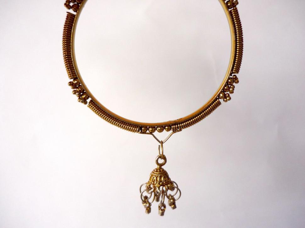 Free Image of Gold Bracelet With Hanging Charm 