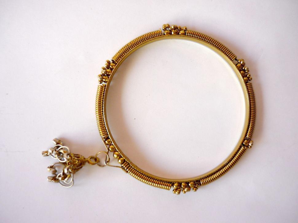 Free Image of Gold Bracelet With Flower Charm 