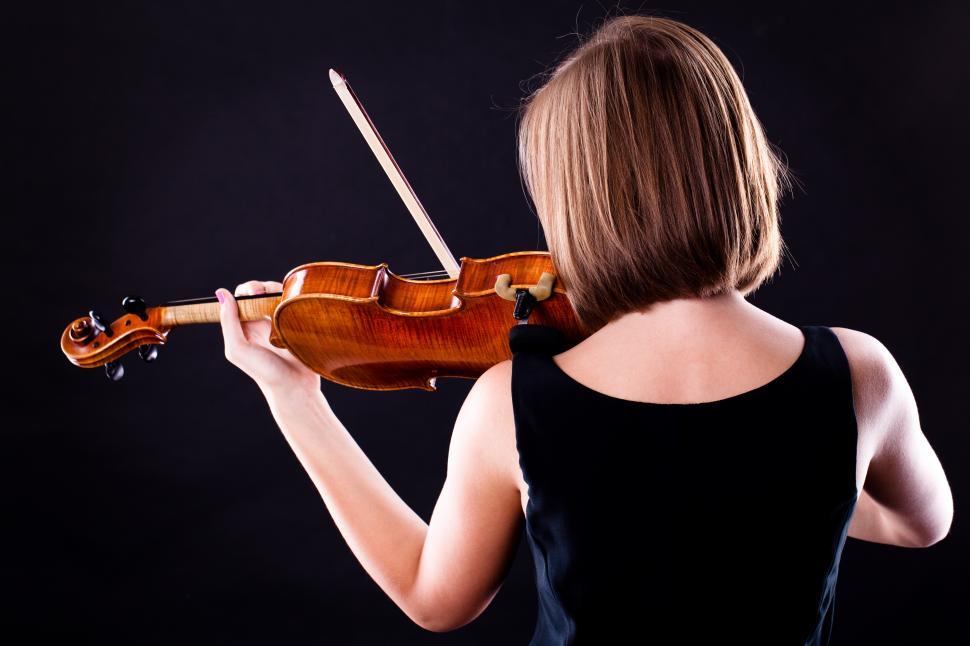 Free Image of Woman playing a violin, back to camera 