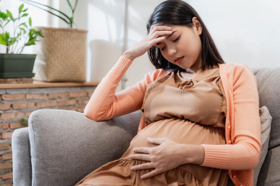 Free Image of Young pregnant asian woman has suffering from headache  