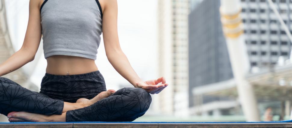 Free Image of Close up hands. Woman doing yoga outdoor in city. 