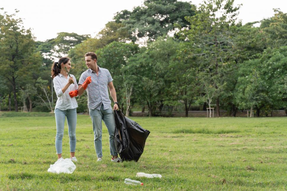 Free Image of Volunteer couple gathering garbage 
