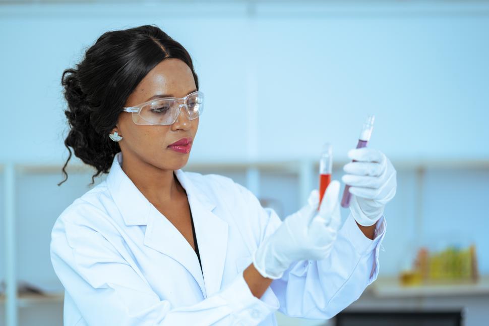 Free Image of Scientist  in laboratory with holding a test tube 