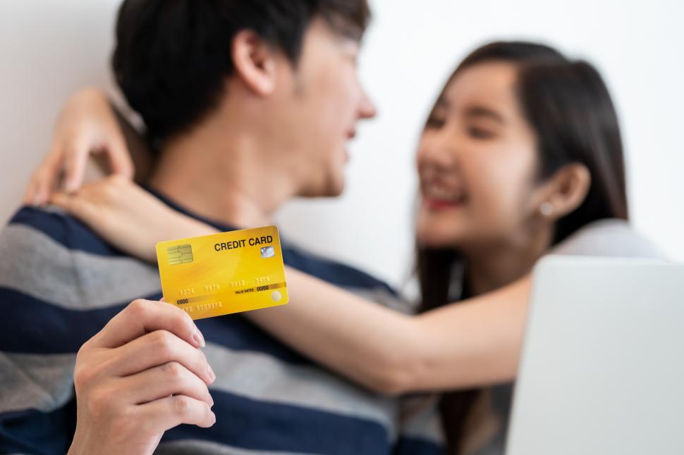 Free Image of Portrait of cheerful Asian couple shopping online 