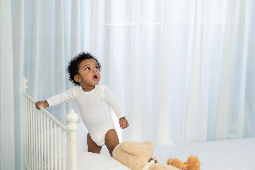 Free Image of Baby boy playing on the bed 