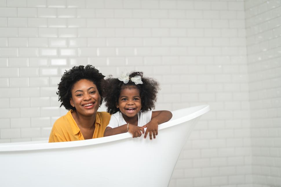 Free Image of African american family, happy mother and baby daughter having fun and playing together at the bathroom 