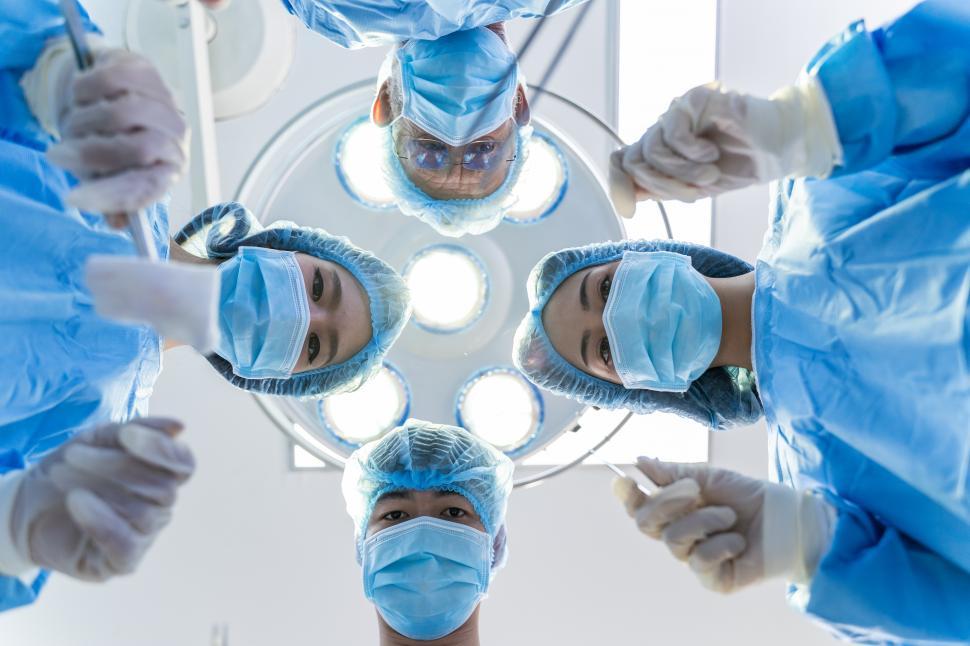 Free Image of Surgical Team Looking down on Patient 