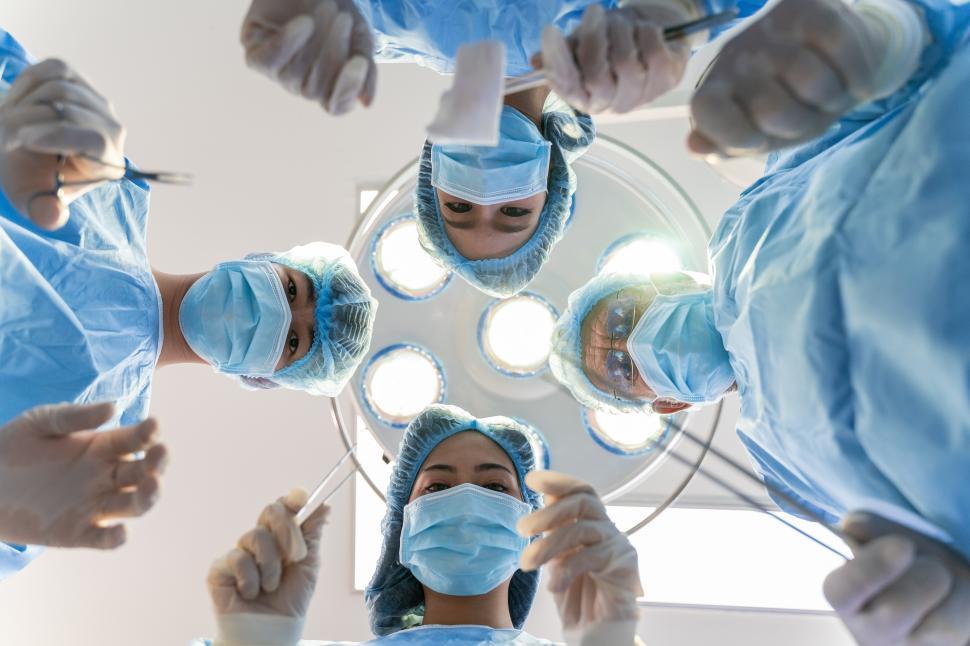 Download Free Stock Photo of Medical Team Performing Surgery, Looking Down 