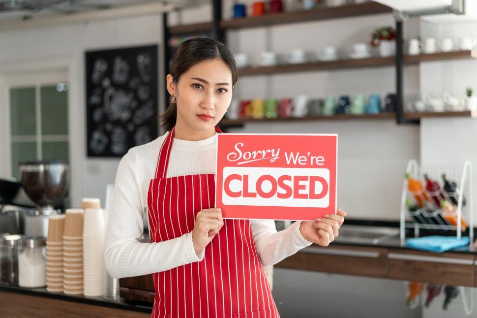 Free Image of Portrait of woman in shop with Closed sign 