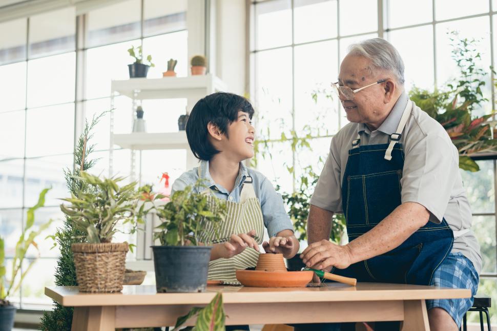 Free Image of Grandfather gardening and teaching grandson 