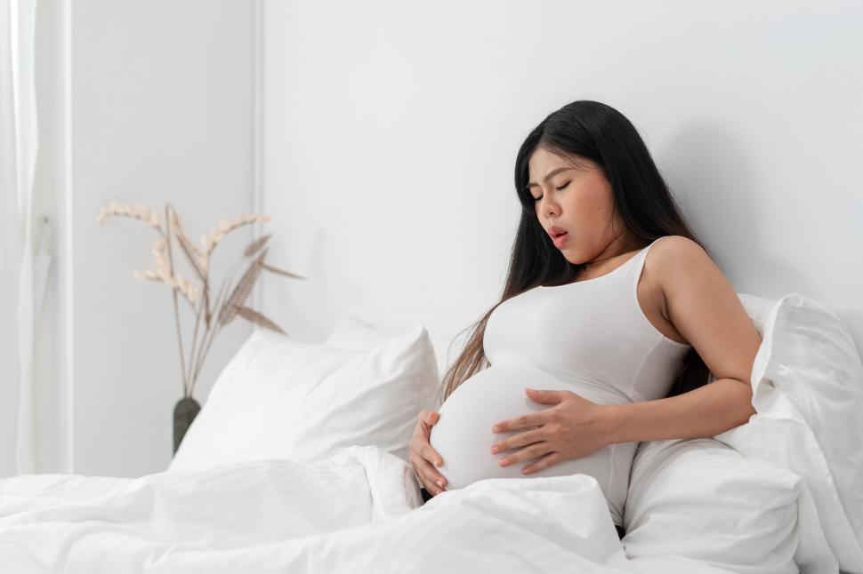 Free Image of pregnant asian woman suffering from back pain 