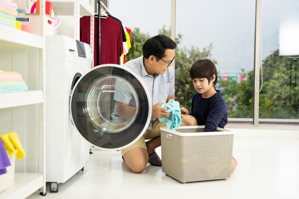 Free Image of Father and son doing laundry 
