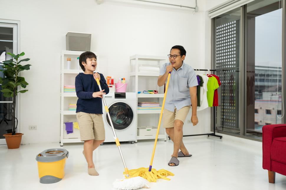 Free Image of Asian father and son do the cleaning in the house 