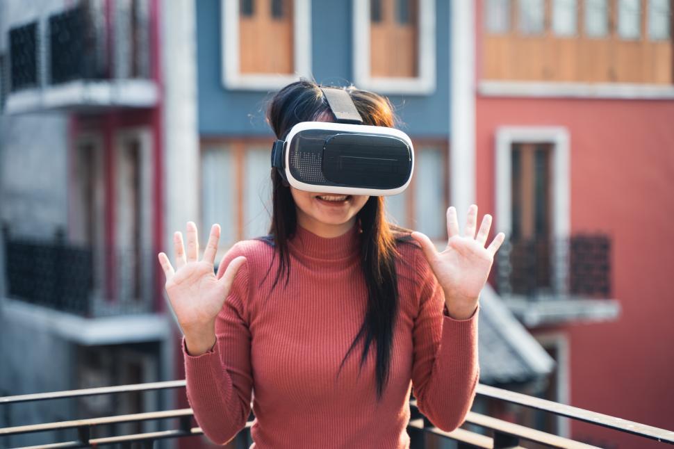 Free Image of woman in red shirt with virtual reality headset 