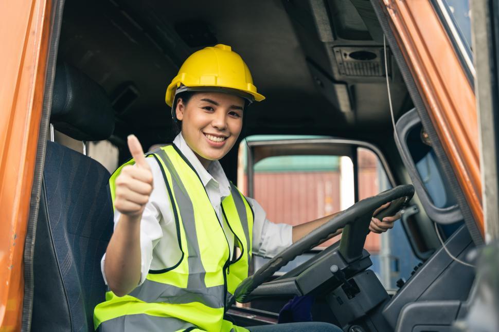 Free Image of Woman truck driver sitting in truck cabin  