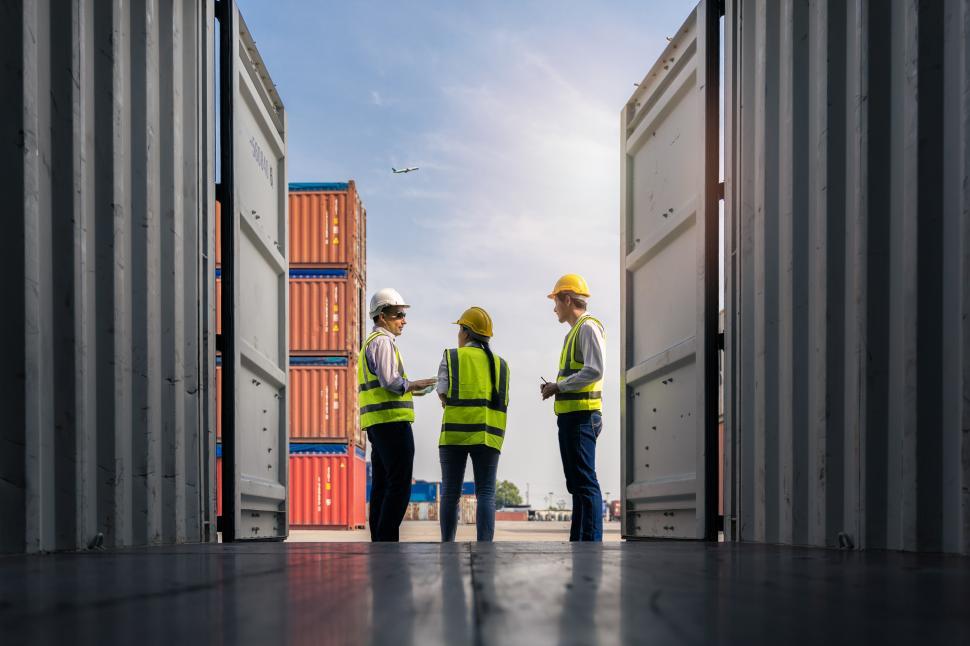 Free Image of Workers standing and checking containers 