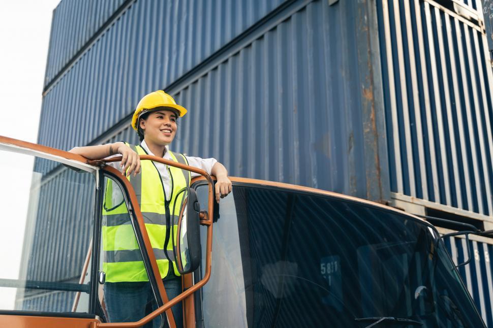 Free Image of Woman truck driver in shipping yard 