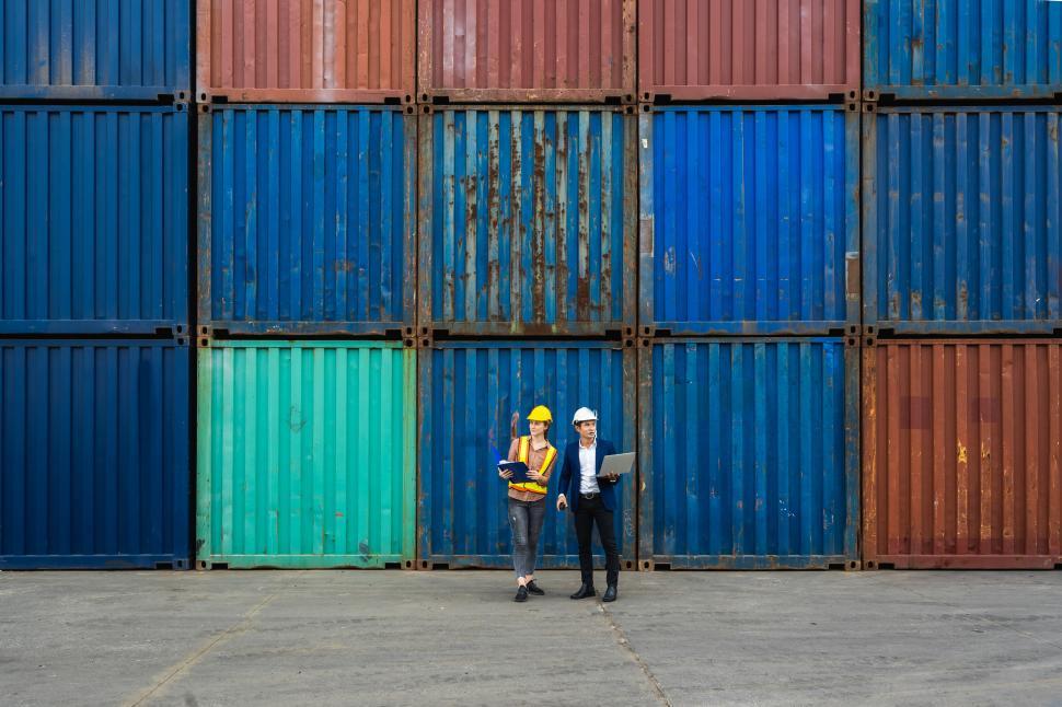 Free Image of Port workers in stack of containers 