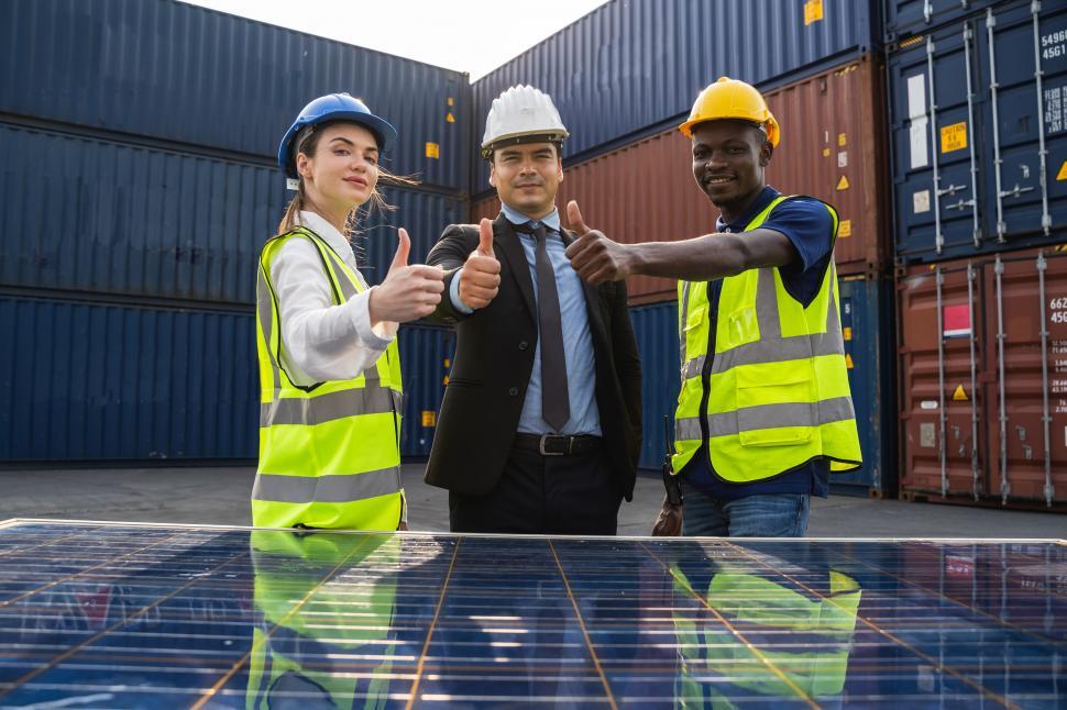 Free Image of Engineers and Technicians with solar panels. Thumbs up. 