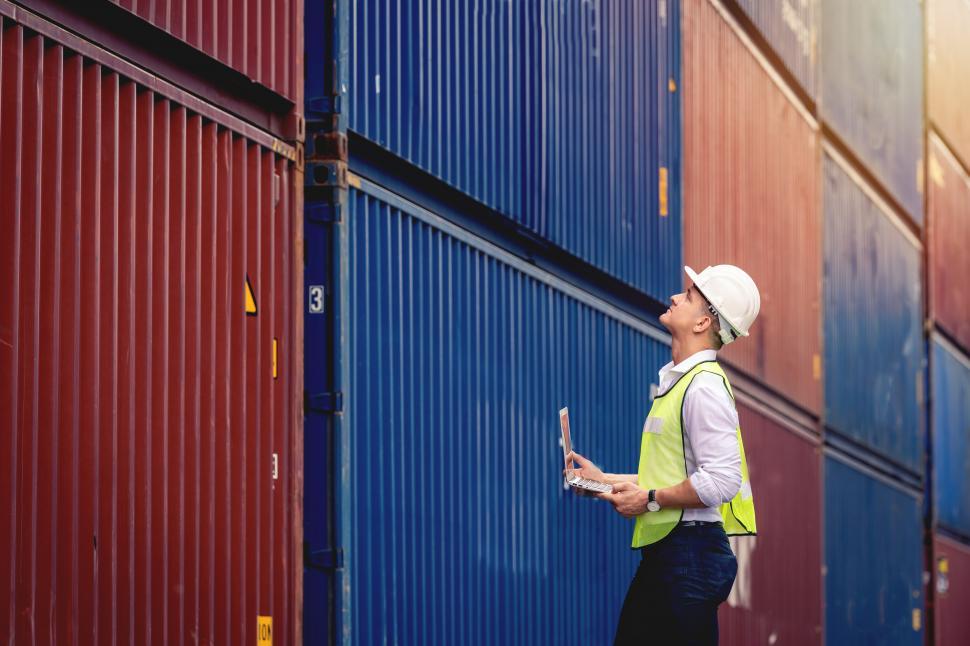 Free Image of Worker inspecting shipping containers 