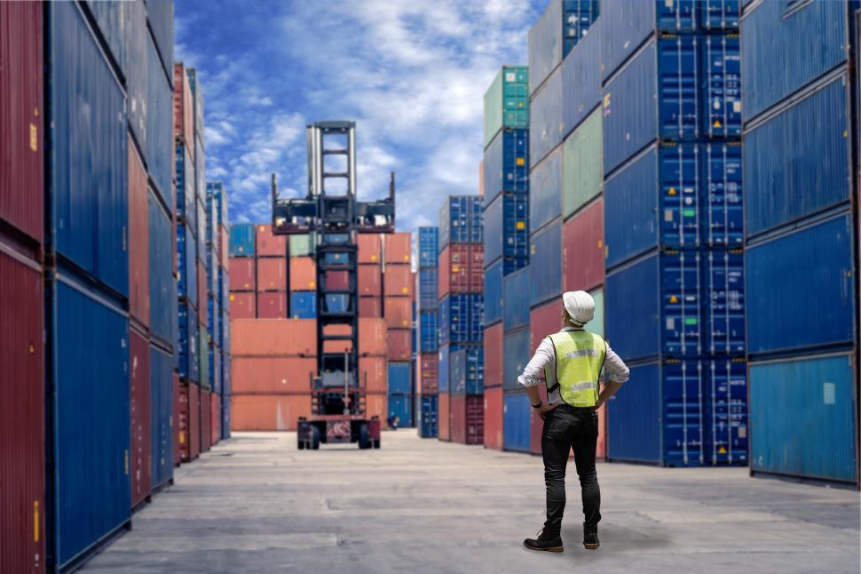 Free Image of Worker walking to check cargo containers 