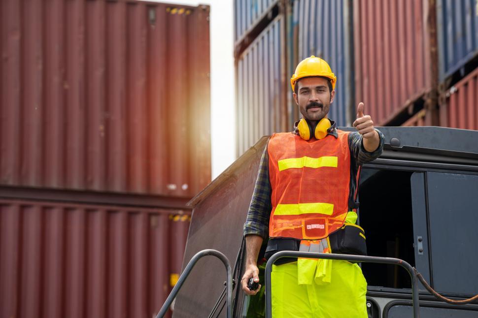 Free Image of Man standing in hard hat, giving thumbs up 