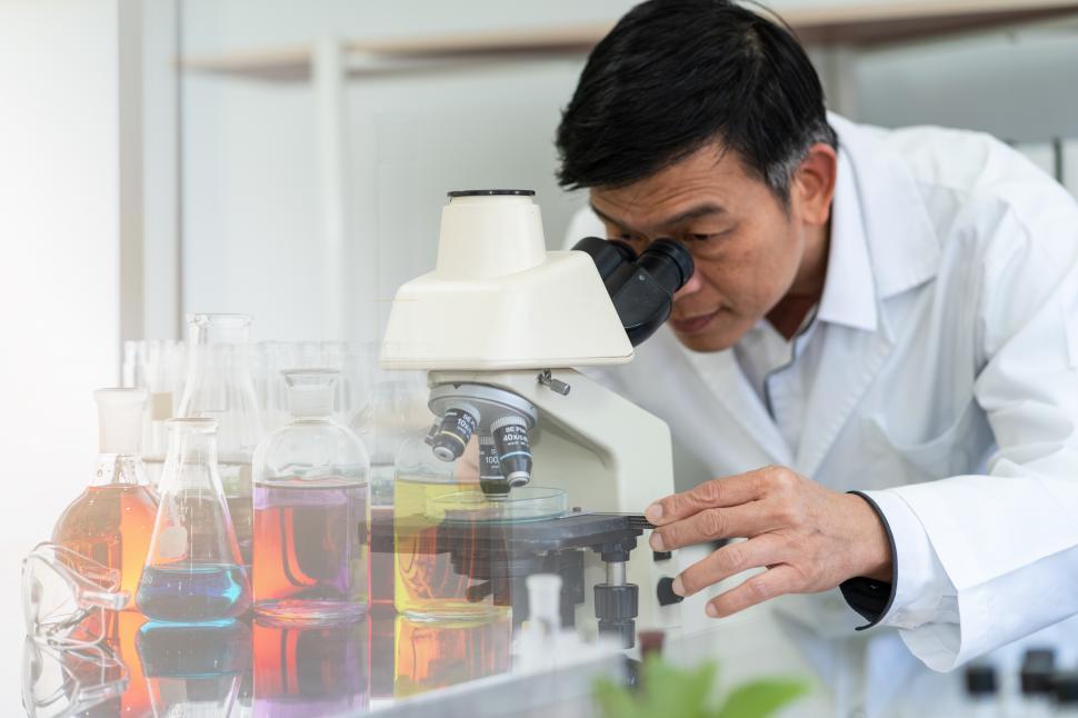 Free Image of Scientist using microscope in laboratory  