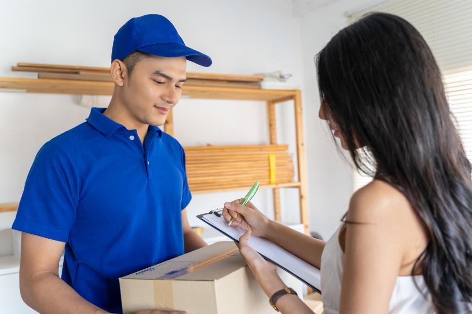 Free Image of Young woman receiving package 