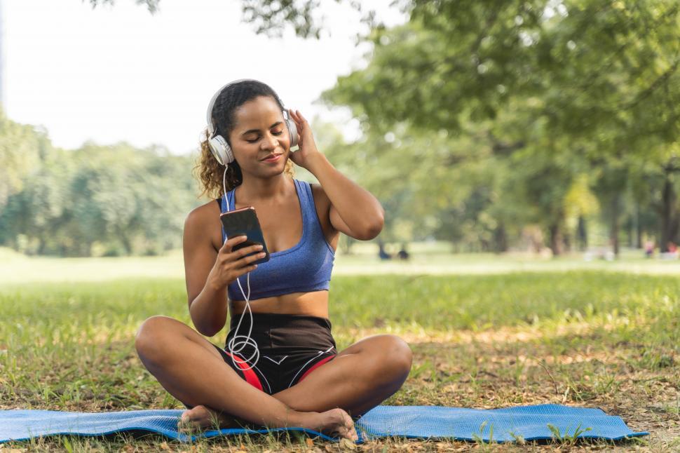 Free Image of Women sitting on a yoga mat in the park 